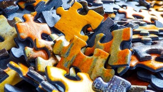 Pile of multi-colored jigsaw puzzle pieces